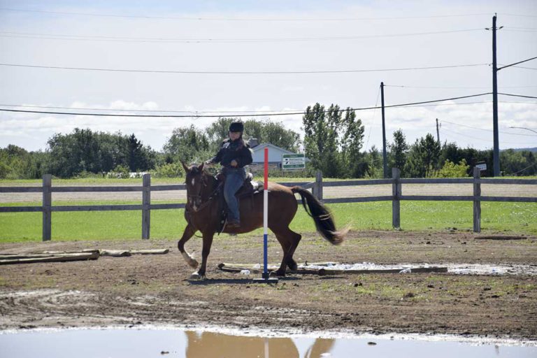 Western Gaming Horse Show participants gallop onto the podium