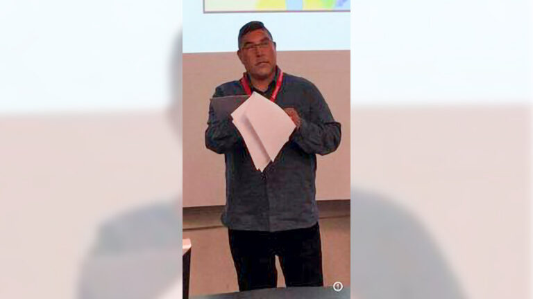 indigenous man lecturing to a university class