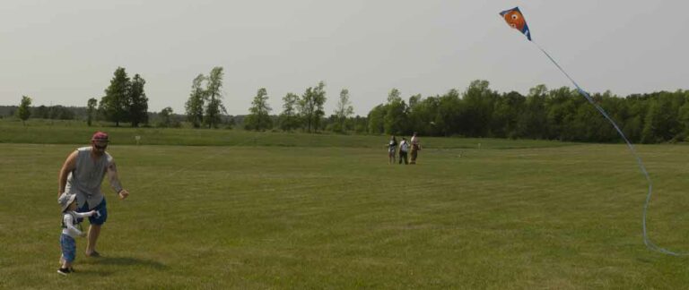 Little people sometimes need a bit of a helping hand while flying their kites. Luckily this dad was on hand to assist in keeping the kite airborne. photo by Isobel Harry