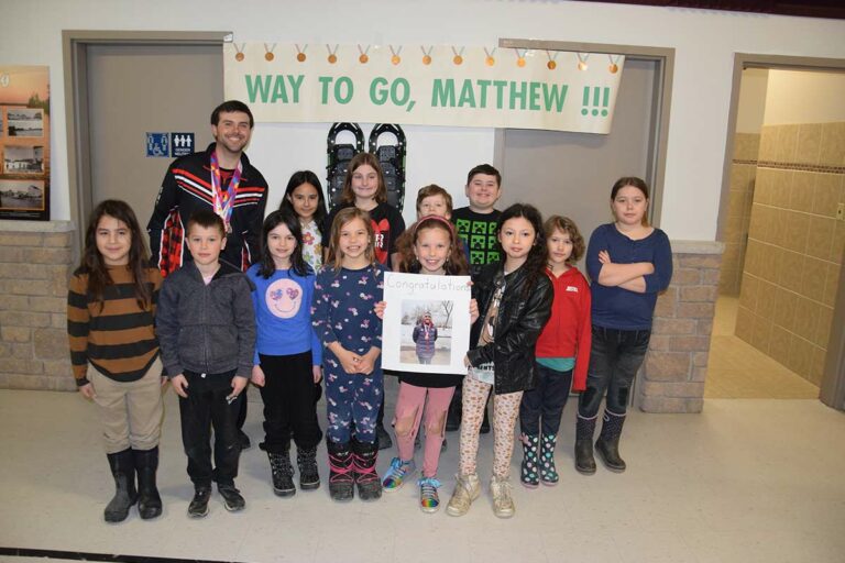 Assiginack students and seniors congratulate Special Olympian