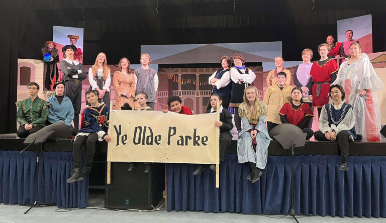 high school musical cast on the edge of stage