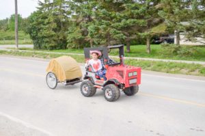 Floats big and small took part in the parade. This tiny tractor hauler was a definite hit.