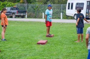 I got this! A tossed ring is  captured in mid-air just before it drops into a hole.