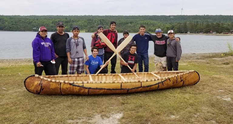Kenj Anishinabek Youth Ambassadors build, launch birchback canoe