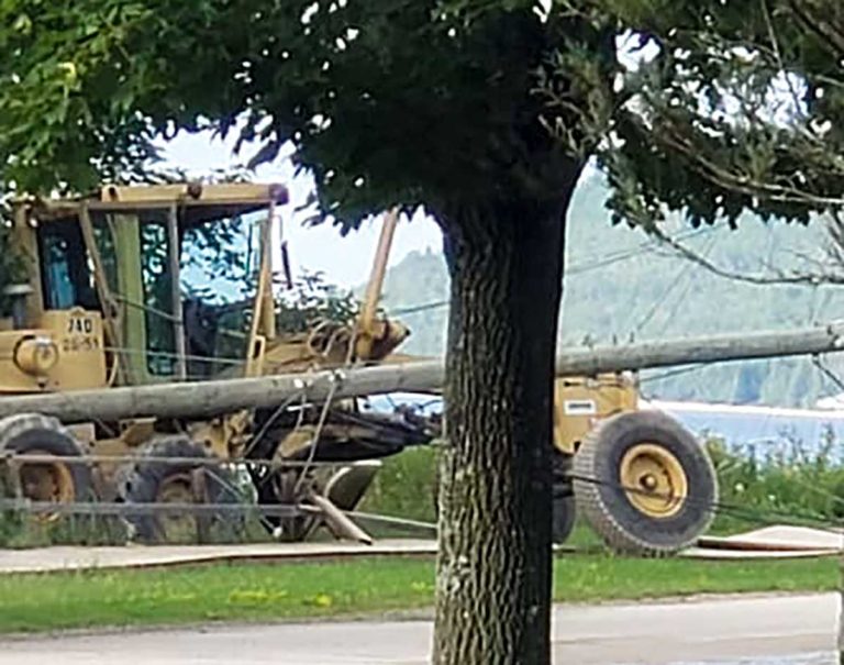 Problem with brakes results in grader knocking down hydro line