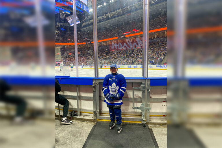 Bryce Debassige, U10 Sudbury Wolf, carries the flag as Leafs affirm Indigenous culture