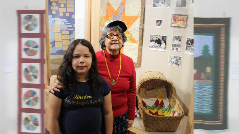 Marion McGregor is shown with her great granddaughter Delia, who was the inspiration for the former to make this beautiful baby blanket quilt. The quilt is one of 17 currently on display at the Ojibwe Cultural Foundation (OCF) in M’Chigeeng First Nation.
