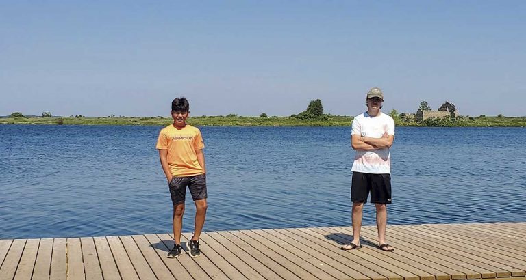 Three  youths work swiftly to rescue swimmer in distress