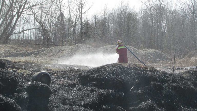 Blaze next to dumpsters at transfer station caused by ashes being dumped