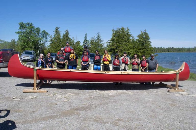 Wiikwemkoong outdoor education class builds, launches 30 ft. canoe
